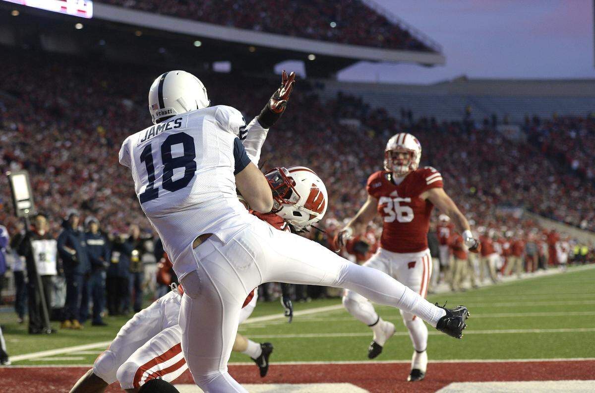 Penn State tight end Jesse James (18) catches a pass from Christian Hackenberg for a touchdown as Wisconsin safety Dezmen Southward (12) defends during Saturday’s game in Wisconsin. (For the CDT/Steve Manuel)