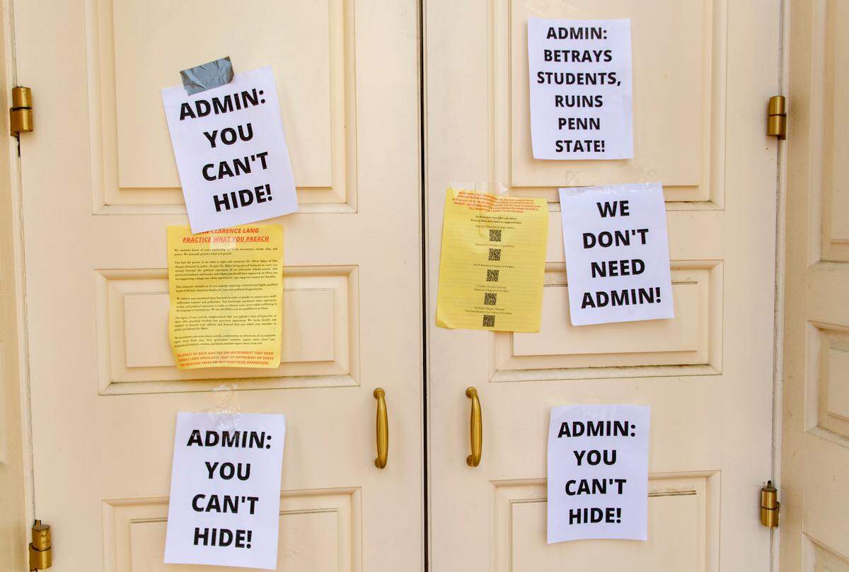 Signs were left on the doors to Old Main by protesters on Thursday afternoon.