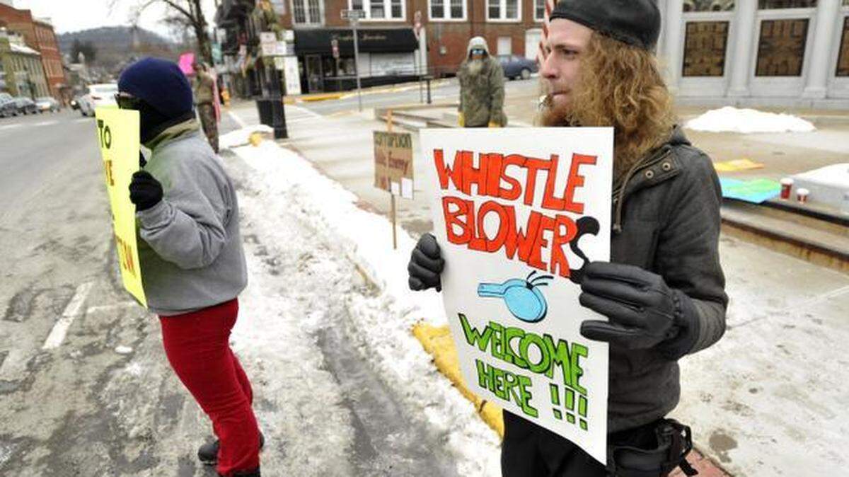 John Adams blows a whistle during a protest in front of the Centre County Courthouse in Bellefonte on Wednesday.

