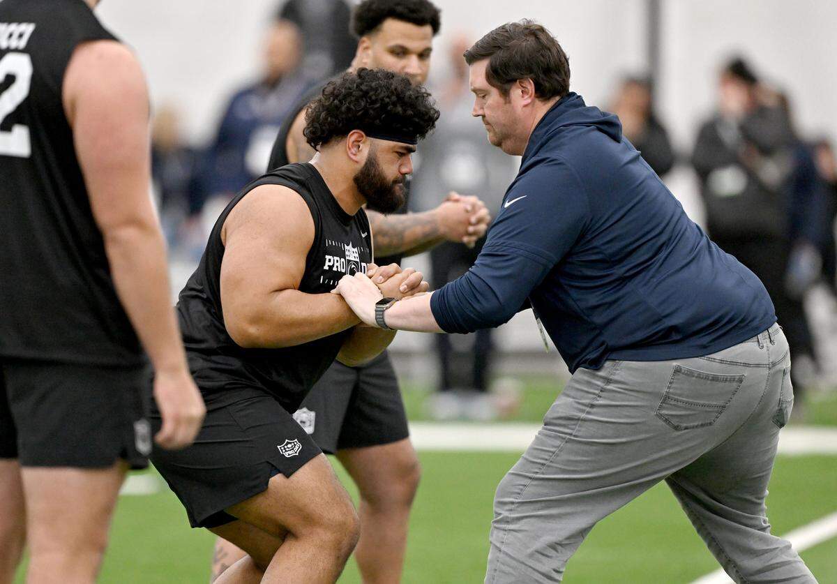 OL Olaivavega Ioane is tested by an NFL scout during Penn State Pro Day on Wednesday, March 18, 2026.  