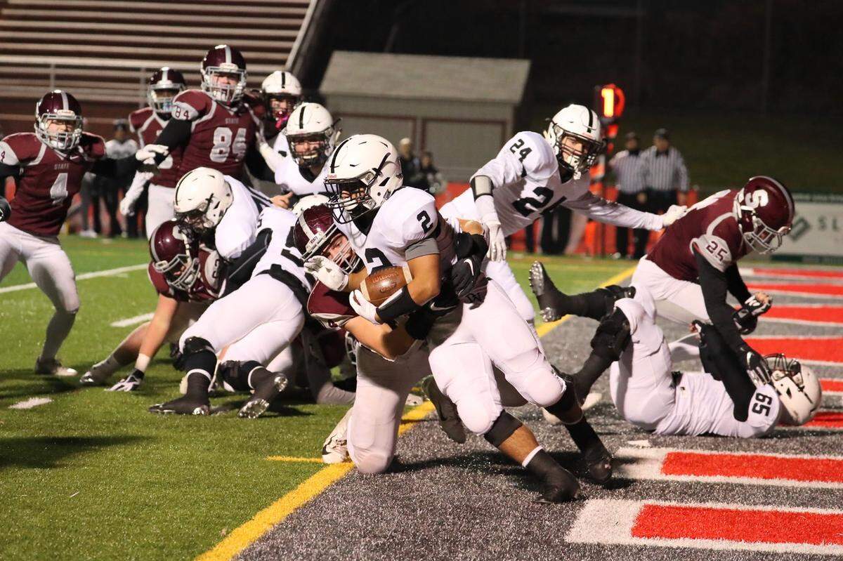 State College’s Kevin Kurzinger pulls down Delaware Valley’s Josh Balcarcel on Friday in the first round of the PIAA football championships at Hazleton. State College won 38-7.