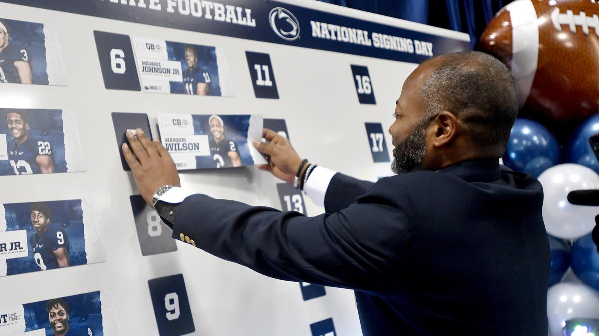 Penn State defensive recruiting coordinator Terry Smith hangs Marquis Wilson’s name on the signing board on Wednesday, Dec. 19, 2018.