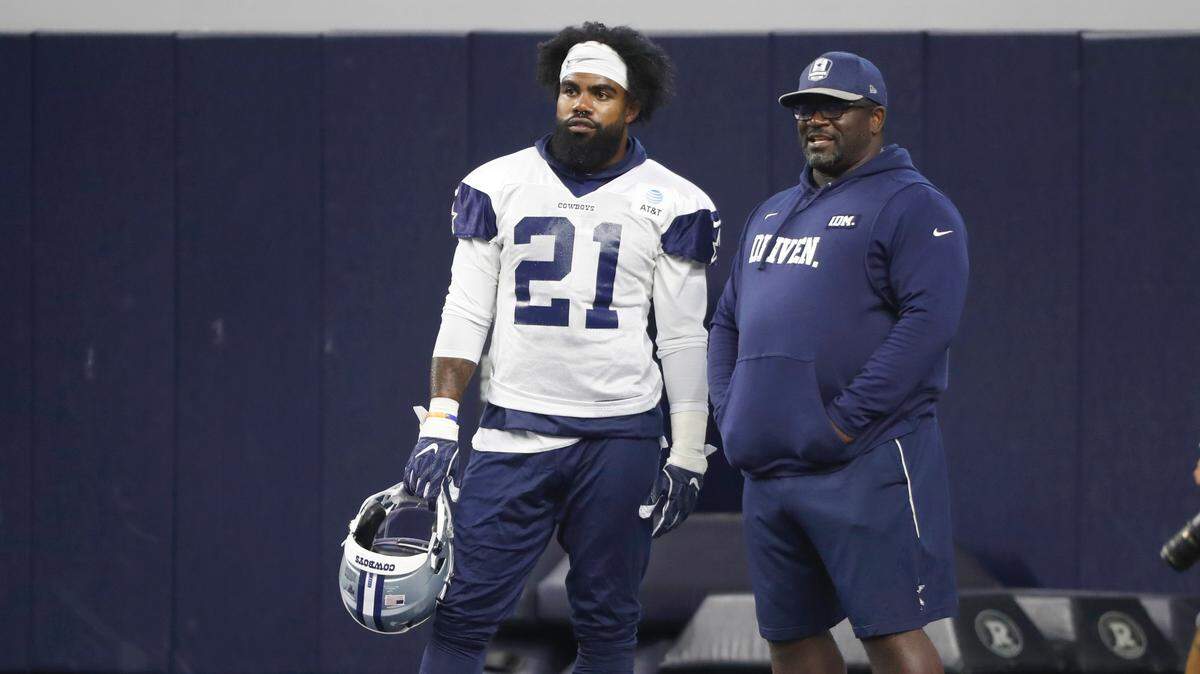 Dallas Cowboys running back Ezekiel Elliott talks with running back coach Gary Brown during a 2019 workout at the team’s practice facility in Frisco, Texas. Brown, who played for Penn State from 1987-90, died Sunday.