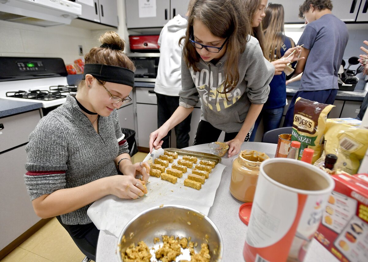 Rebecca Dean and Anna Hegedus work together to make dog biscuits on Oct. 3.  Students in the veterinary science class at Bald Eagle Area High School have been working to create dog treats that will be sold at upcoming events.