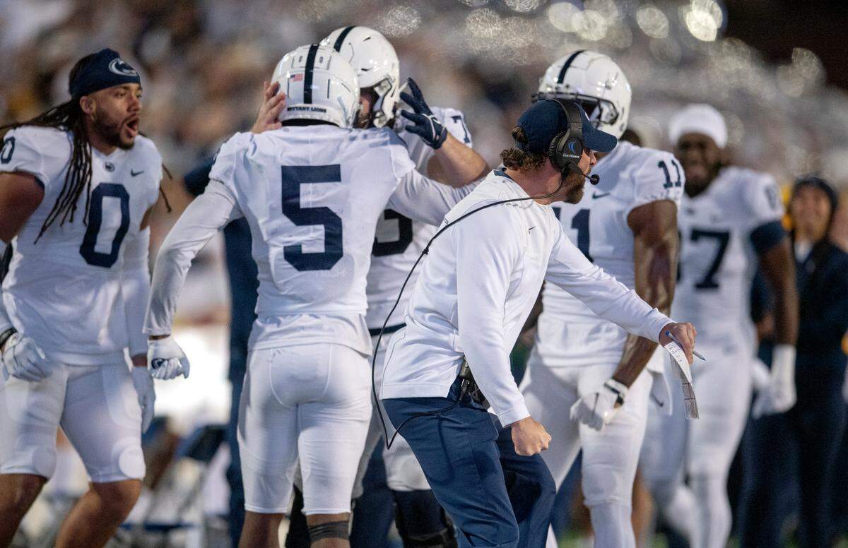 Penn State offensive coordinator Mike Yurcich celebrates as Jahan Dotson is congratulated by teammates after a touchdown in the game against Maryland Saturday, Nov. 6, 2021.