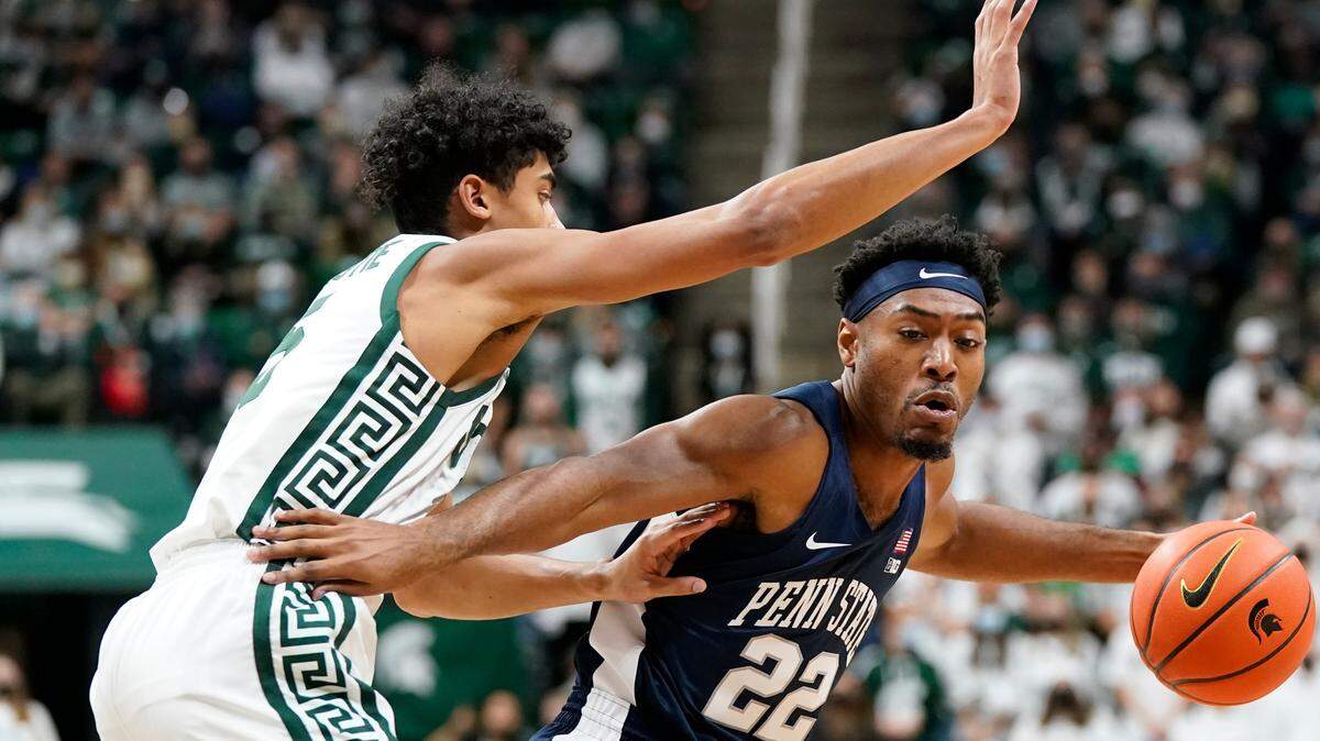 Penn State guard Jalen Pickett (22) is defended by Michigan State guard Max Christie (5) during the first half of an NCAA college basketball game, Saturday, Dec. 11, 2021, in East Lansing, Mich.