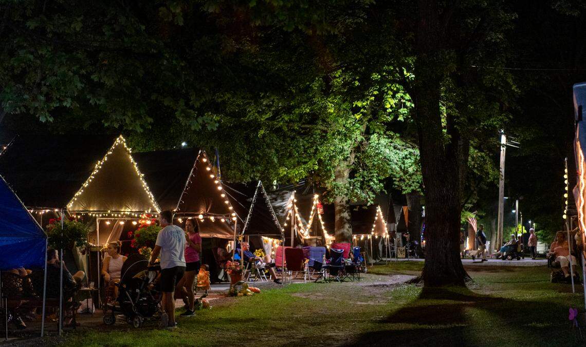 Families and friends visit at their tents at the Centre County Grange Fair on Thursday, Aug. 26, 2021.
