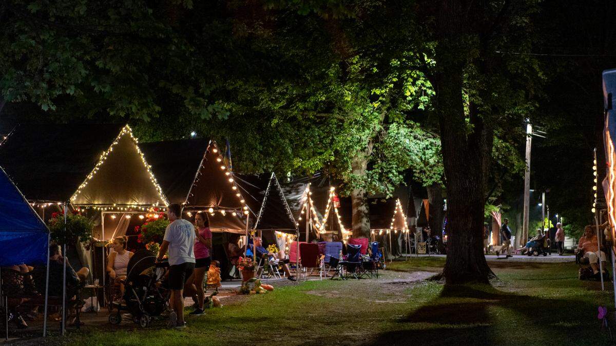 Families and friends visit at their tents at the Centre County Grange Fair on Thursday, Aug. 26, 2021.