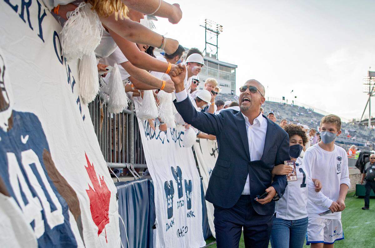 Penn State football coach James Franklin greets fans with his daughter before the game against Auburn.