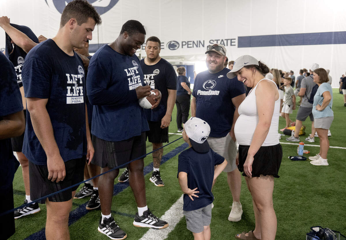Penn State offensive lineman Anthony Donkoh signs an autograph for a young fan after Lift For Life on Wednesday, July 1, 2026.