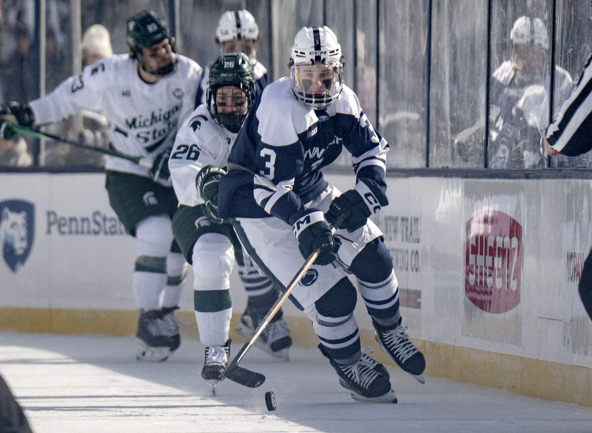 Penn State's Casey Aman skates down the ice with the puck ahead of a Michigan State defender during the game at Beaver Stadium on Saturday, Jan. 31, 2026.