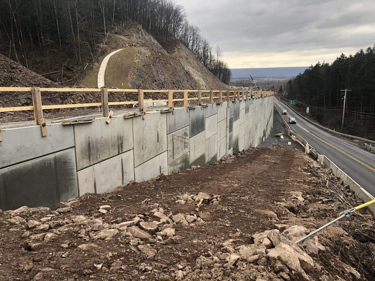 A recently complete retaining wall that runs along Route 322.