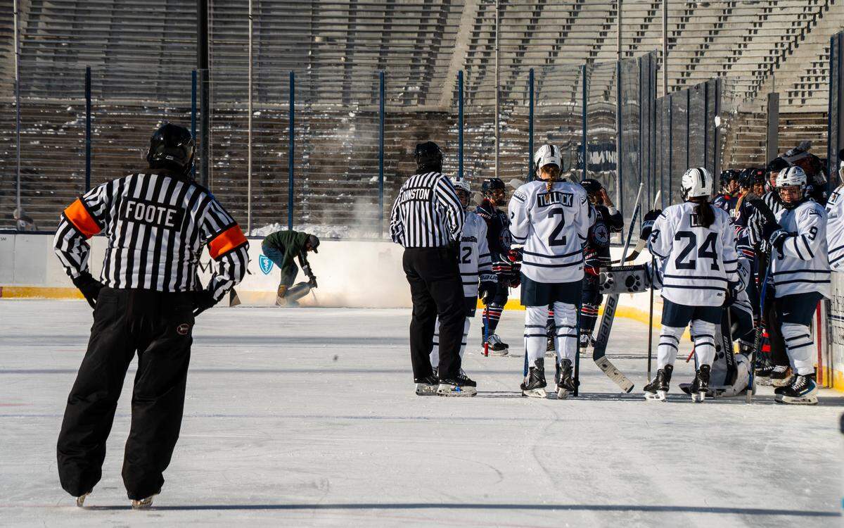 The Penn State women’s hockey team speaks with the referee during a break to conduct maintenance on the north eastern corner of the ice rink during the Penn State women’s hockey game at Beaver Stadium on Friday, Jan. 30, 2026.The Nittany Lions played at Beaver Stadium for the first time and defeated the Colonials 3-1.