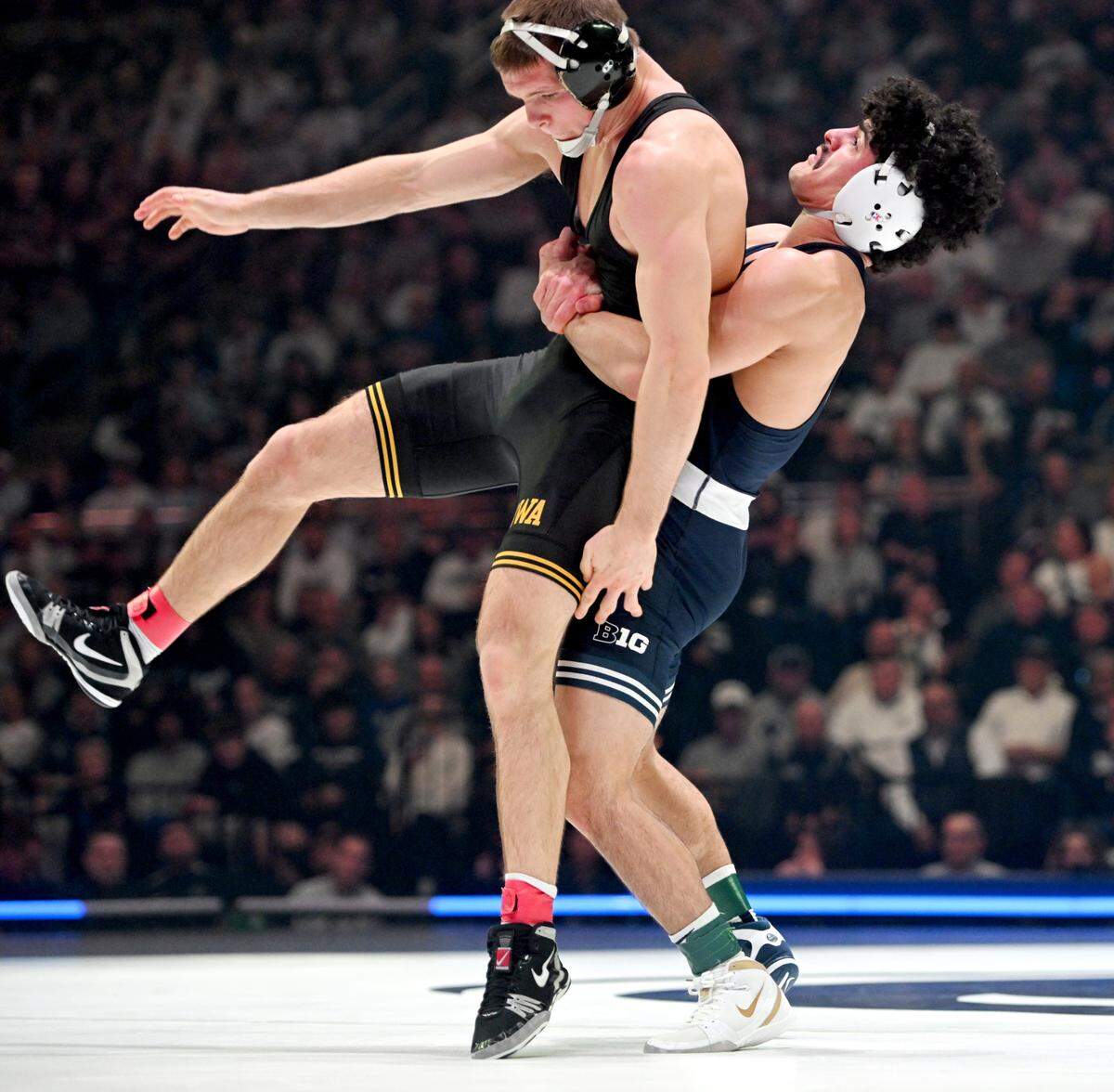 Penn State’s Beau Bartlett brings down Iowa’s Cullan Schriever in the 141 lb bout of the match on Friday, Jan. 31, 2025 at the Bryce Jordan Center. Bartlett won by decision, 7-3.