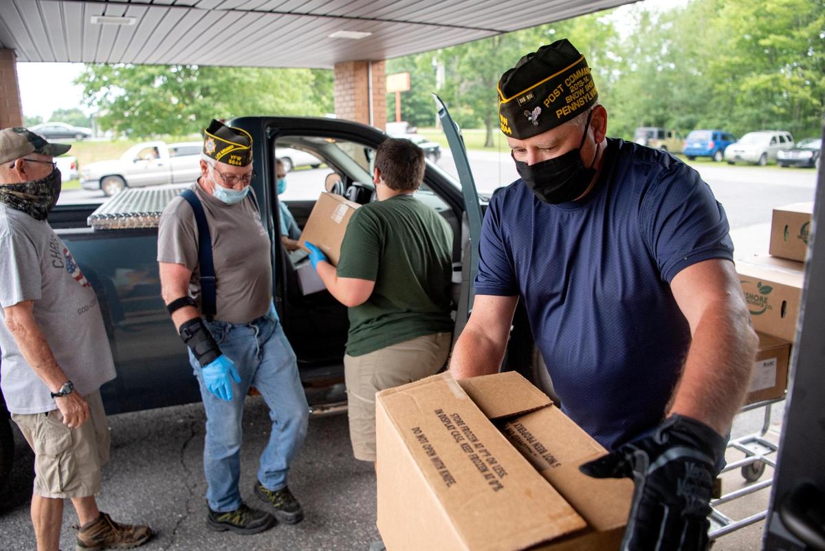 Volunteers Bruce Houck, George Crock, Eli Fry and Mike Guenot help distribute food boxes to those in need on Thursday, July 23, 2020 at the Mountain Top Alliance Church. Crock and Guenot, both members of the Snow Shoe VFW Post 5644, donate their time to help around the community.