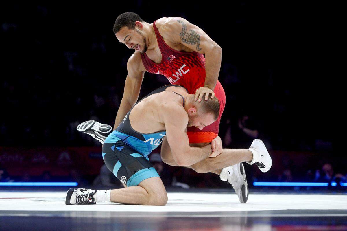 David Taylor reaches for Aaron Brooks in the second bout of their best-of-three series final at 86 kg during the U.S. Olympic Team Trials at the Bryce Jordan Center on Saturday, April 20, 2024. Brooks won, 3-1.