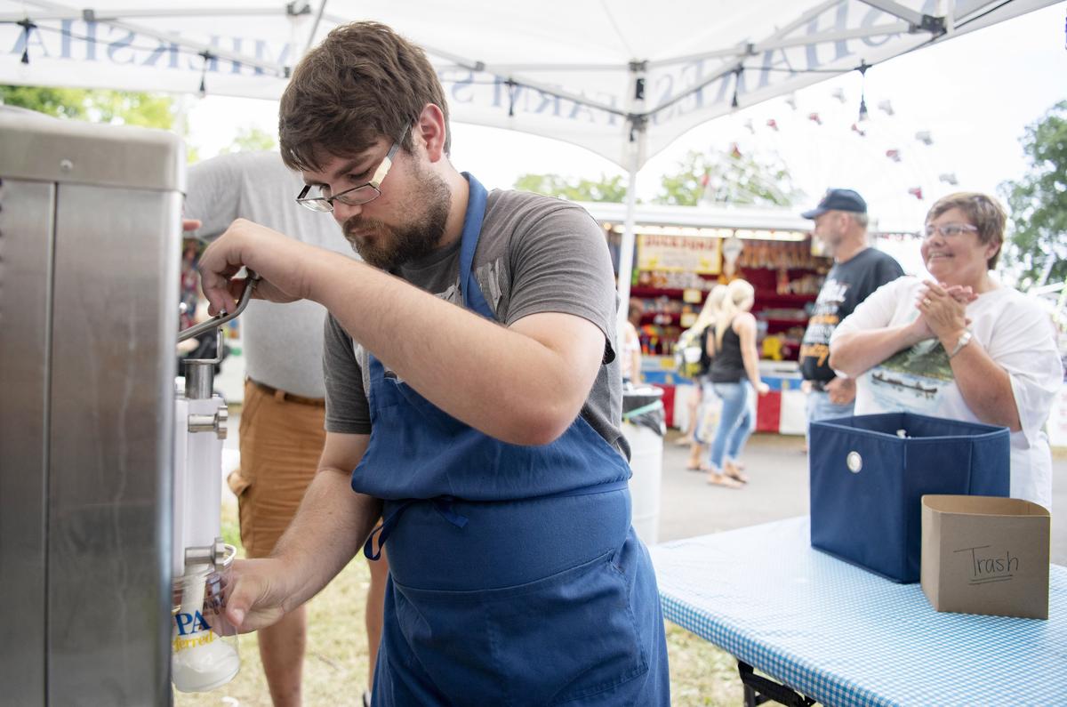 Joey Schafer serves up a vanilla milkshake at Taproot Kitchen and the Pennsylvania Dairyman’s Association booth at the Centre County Grange Fair on Thursday.