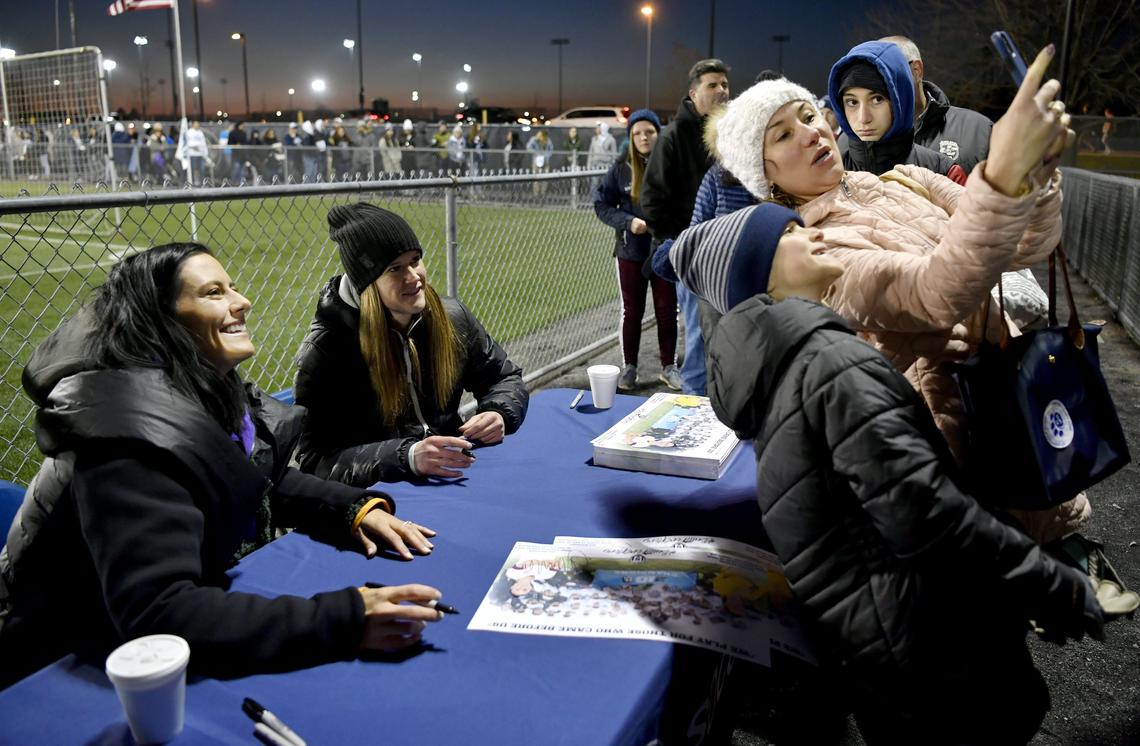 USA World Cup champions Ali Krieger, left, and Alyssa Naeher sign autographs for fans and smile for selfies before a 2019 Penn State postseason game. Krieger is running for an open alumni seat on Penn State’s board of trustees.