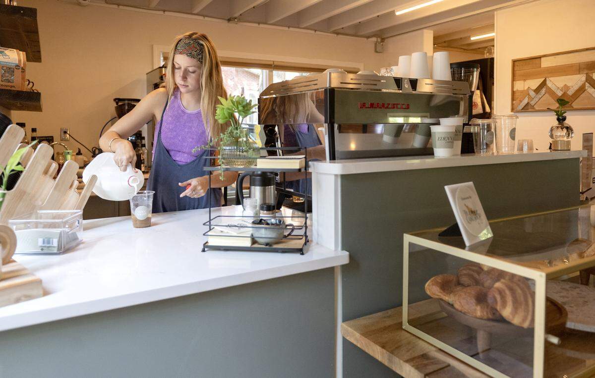 Zoe Duffus makes a drink for customer at Eden Valley Coffee Company on Wednesday, July 30, 2025.