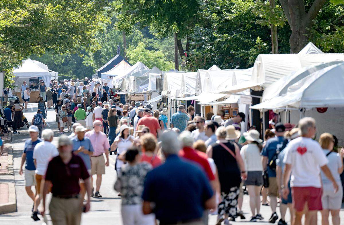 Visitors visit the artists along Allen Street during the Central Pennsylvania Festival of the Arts on Friday, July 11, 2025.