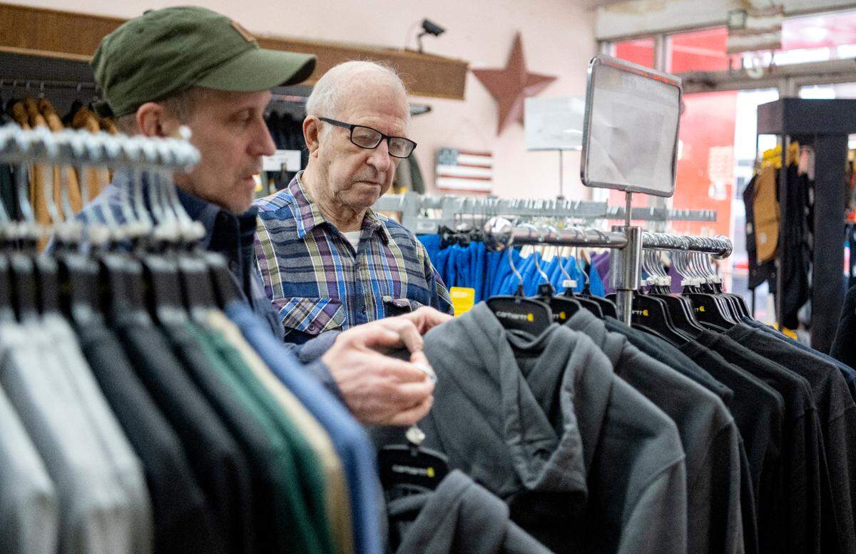 Don and Ron Rothrock organize a rack of sweatshirts at Rothrocks Clothing and Shoes on Front Street in Philipsburg on Feb. 8, 2023.