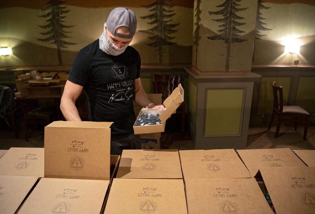 Mike Tedesco of Happy Valley Nomadic Spirits works on packing up the December boxes that were themed around rye whiskey on Monday, Dec. 14, 2020.