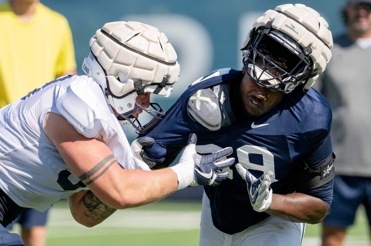 Penn State offensive lineman Landon Tengwall and defensive tackle Coziah Izzard run a drill during practice on Saturday, Aug. 20, 2022.