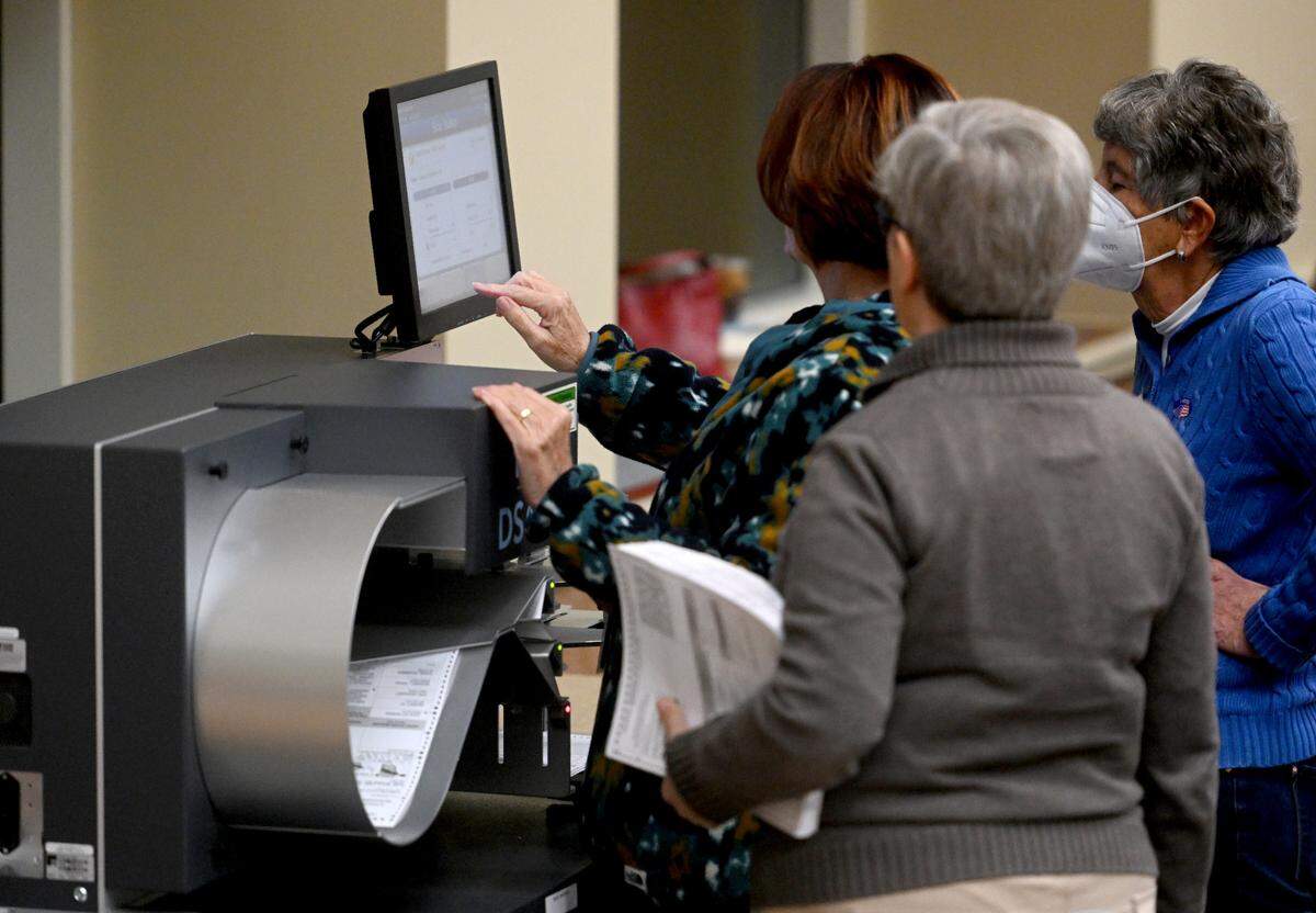 Volunteers open and scan mail-in ballots at the Penn Stater on Tuesday, Nov. 8, 2022.