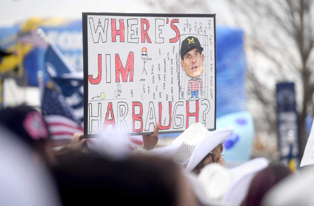 Penn State fans hold up signs at the Big Noon Kickoff about Jim Harbaugh before the game on Saturday, Nov. 11, 2023.