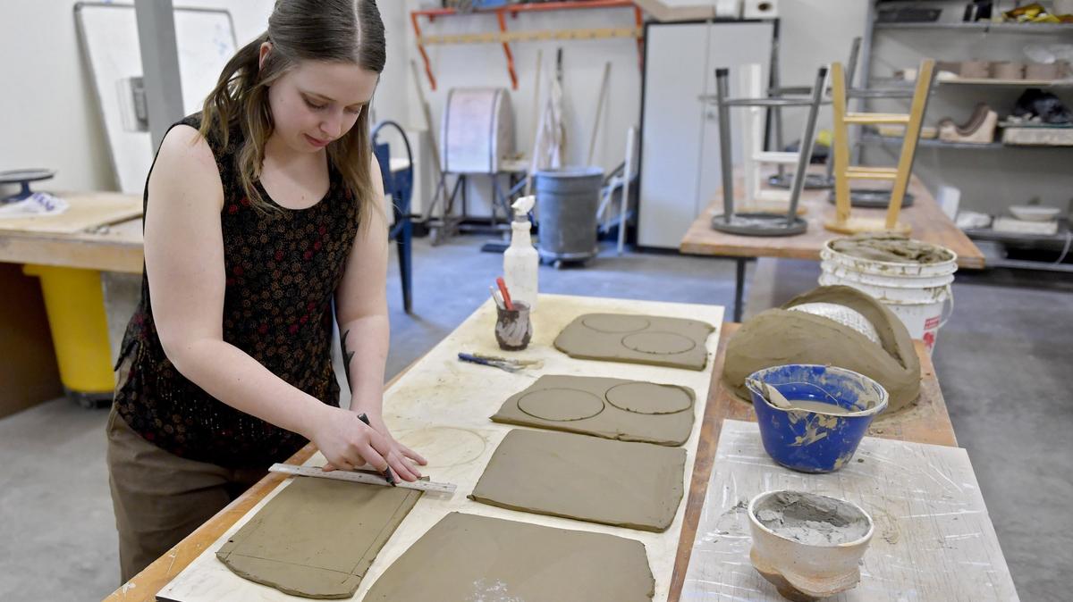 Danielle Spewak works with clay in a studio space at Penn State on March 28. Speak has created several mosaics around town, including the blue lobster inside of Maine Bay & Berry Co.