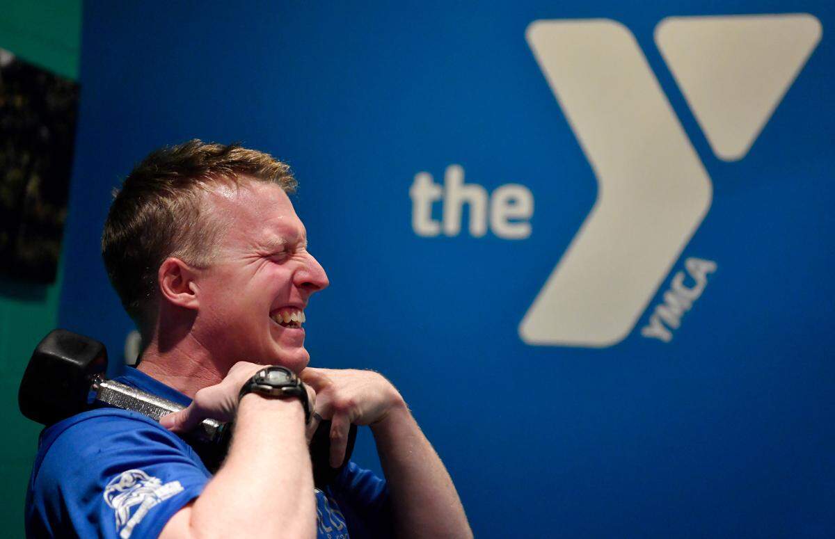 Josh Cone laughs with members in his Zoom exercise class at the State College YMCA on Tuesday, Feb. 2, 2021.