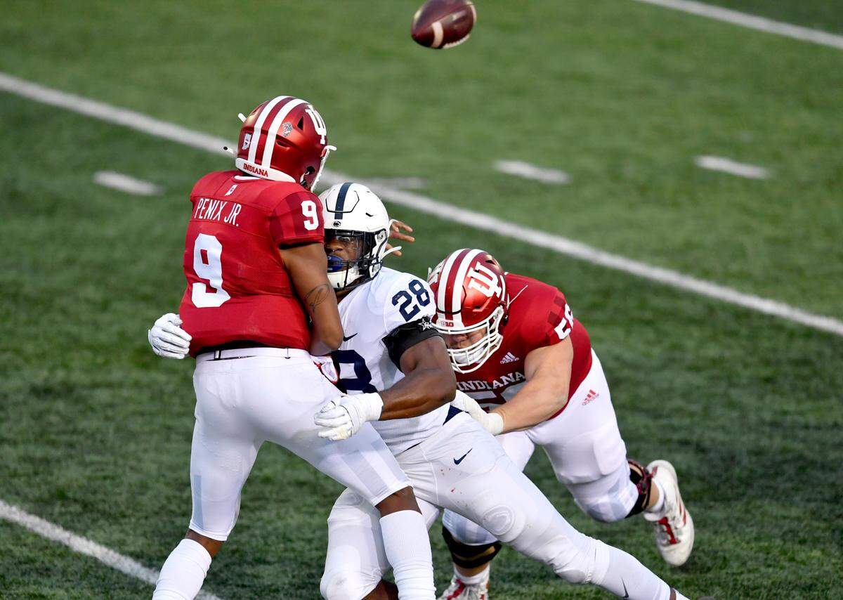 Penn State defensive end Jayson Oweh hits IndianaÕs Michael Penix Jr. as he makes a pass during the game on Saturday, Oct. 24, 2020 at Memorial Stadium.