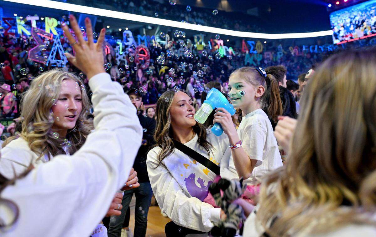 Shiloh Crimmel, 8, blows bubbles with the dancers from the Lionettes during Penn State Thon on Friday, Feb. 21, 2025.
