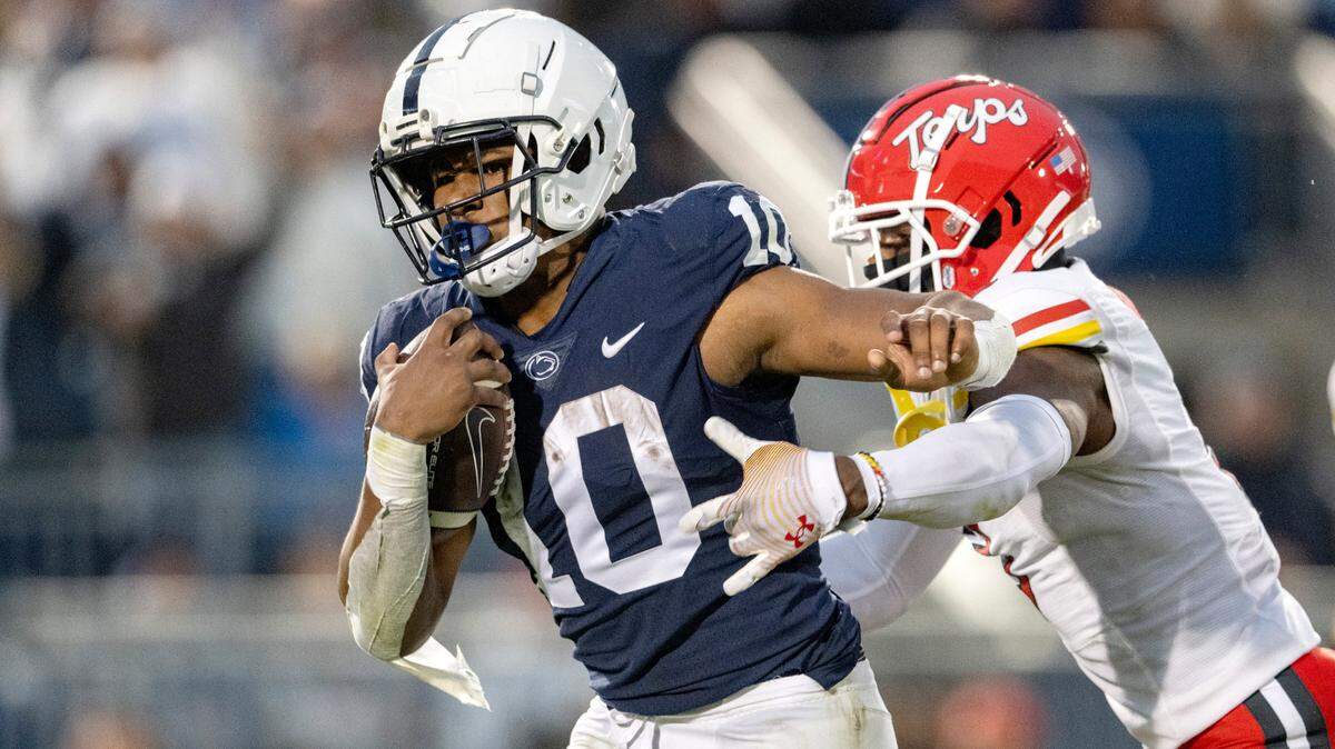 Penn State running back Nick Singleton escapes the grasp of Maryland defenders for a touchdown during Saturday’s game. The Nittany Lions were No. 11 in the latest College Football Playoff rankings released Tuesday.