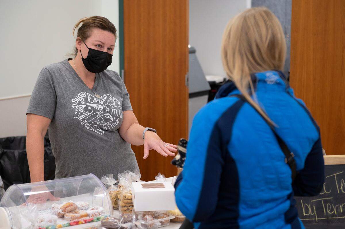 Terri Spahr, owner of Sweet Temptations by Terri, speaks to a customer Tuesday at the Boalsburg Farmers Market.