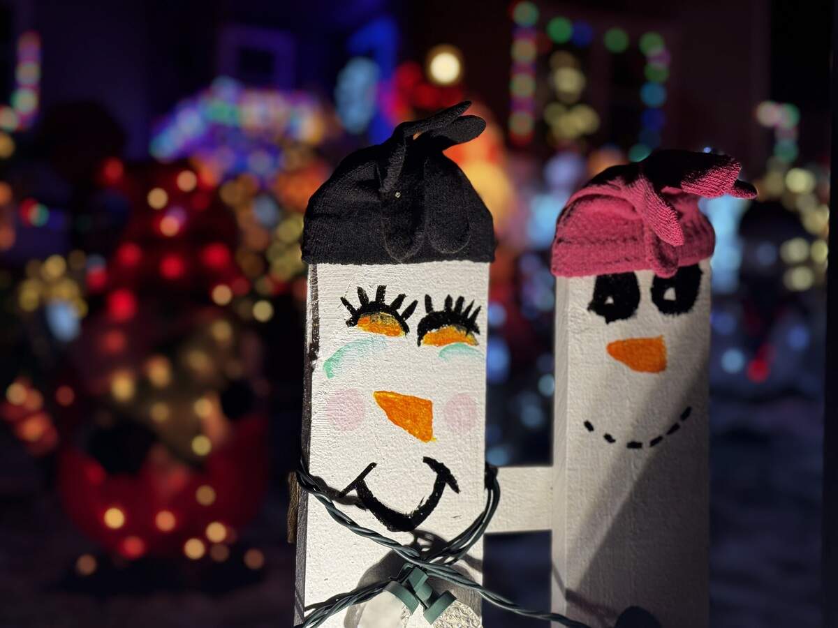 Fence posts are hand painted to resemble snowmen at 1231 Shamrock Ave., State College, on Dec. 4, 2025.