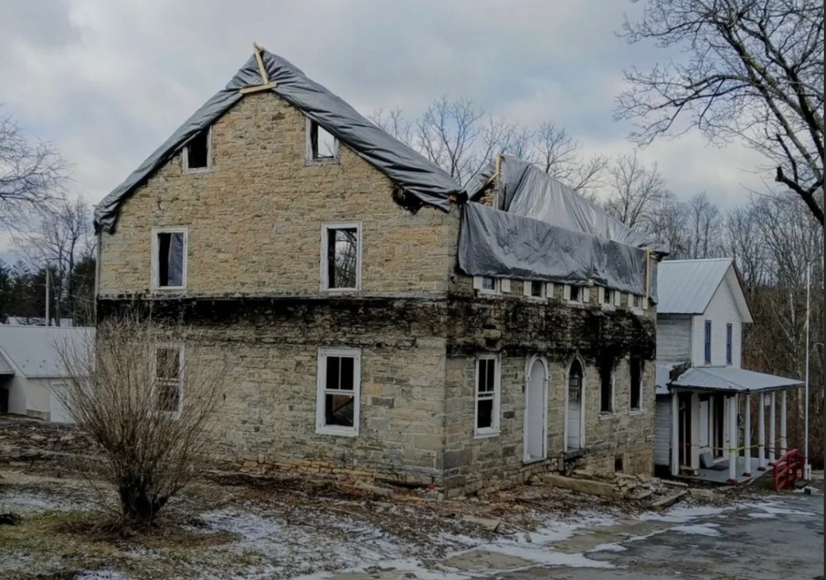 The front of the Woodward Inn is tarped after undergoing a demolition.
