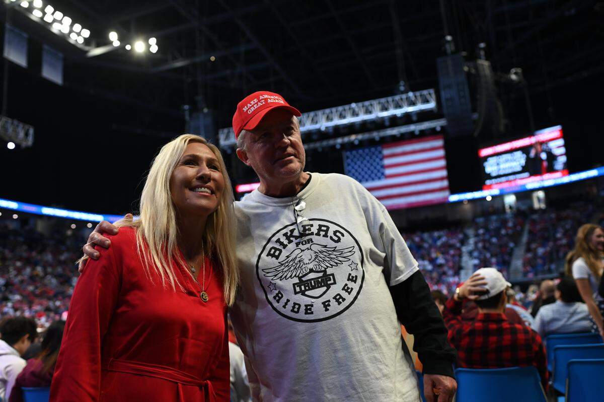 Representative Marjorie Taylor Greene poses for a picture with a Donald Trump supporter at the Bryce Jordan Center during a Trump rally on Saturday, Oct. 26, 2024.
