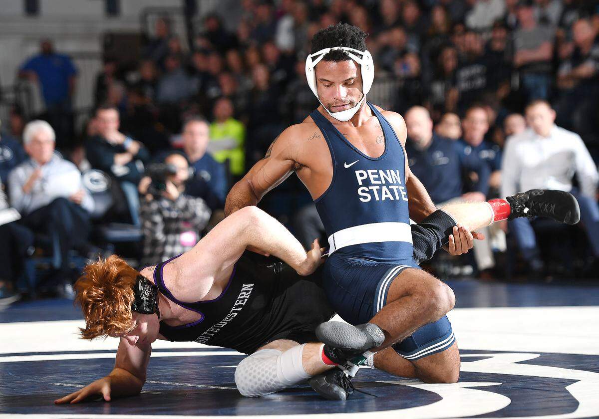 Penn State’s Mark Hall (bottom) works for a take-down of Northwestern’s Tyler Morland during Sunday’s match at Rec. Hall. Hall defeated Morland in a 17-2 technical fall. Penn State defeated Northwestern 30-9. (For the CDT/Steve Manuel)