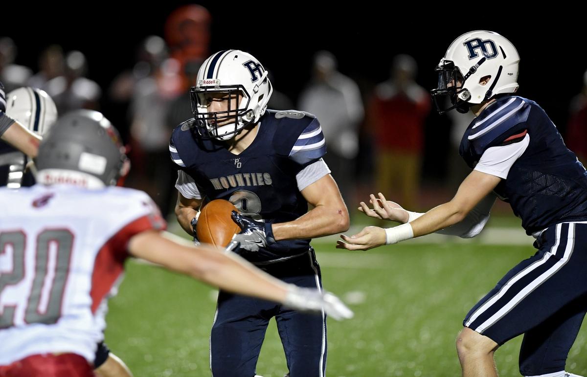 Philipsburg-Osceola quarterback Jeremy Whitehead hands off to Dakote Hofe during the game against Central on Friday, Sept. 27, 2019.