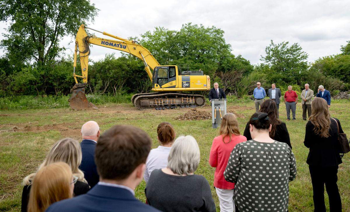 Happy Valley Adventure Bureau CEO and President Fritz Smith speaks during the groundbreaking ceremony for the Tru Hotel by Hilton that will be built along Benner Pike on Tuesday, June 11, 2024.