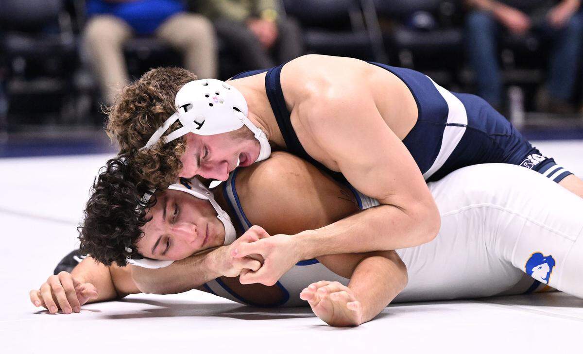 Penn State’s MItchell Messenbrink puts a lock on Hofstra’s Matthew Waddell (165 lbs) during Sunday’s match at Recreation Hall at University Park. Messenbrink defeated Waddell by a pin.