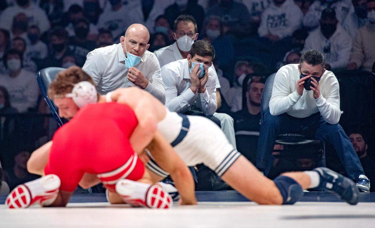 Penn State wrestling coaches Cael Sanderson, Jimmy Kennedy and Cody Sanderson yell to Terrell Barraclough (in white) during his 157-lb. bout on Friday, Feb. 4, 2022.
