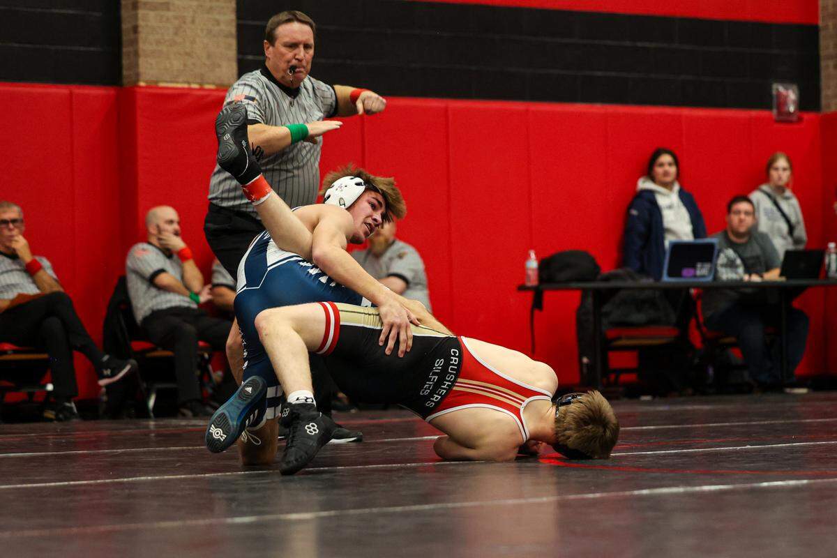 Philipsburg-Osceola’s Caleb Hummel looks to score the winning takedown against Bishop McCort’s Jack Silfies in their 121-pound finals match of the Laurel Highlands Athletic Conference championships on Jan. 4 at Central Cambria High School in Ebensburg. Hummel did get a takedown for a 7-5 win.