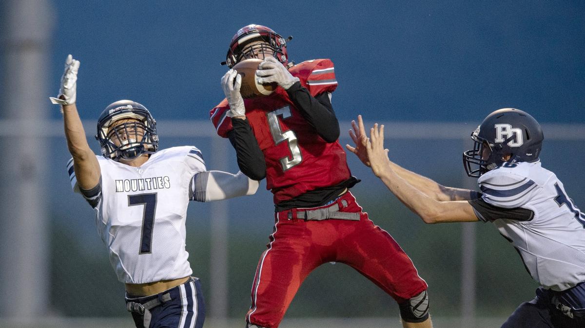 Bellefonte’s Trae Bauman makes a catch over Philipsburg-Osceola defenders at Lock Haven University.