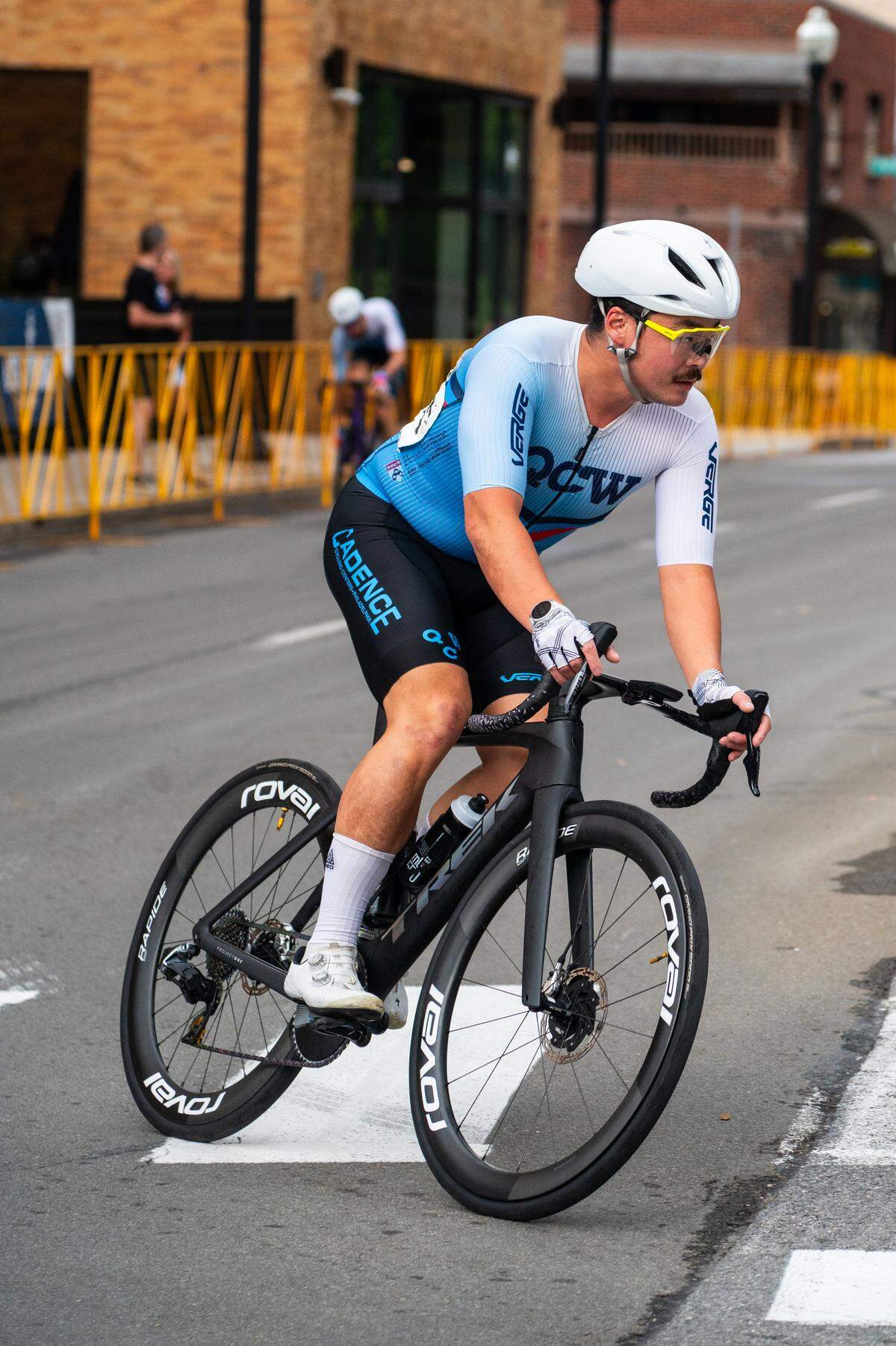 A cyclist in the Men’s Cat 1 and Cat 2 race goes around a corner during the State College Criterium on Saturday, July 26, 2025 in State College, Pa.