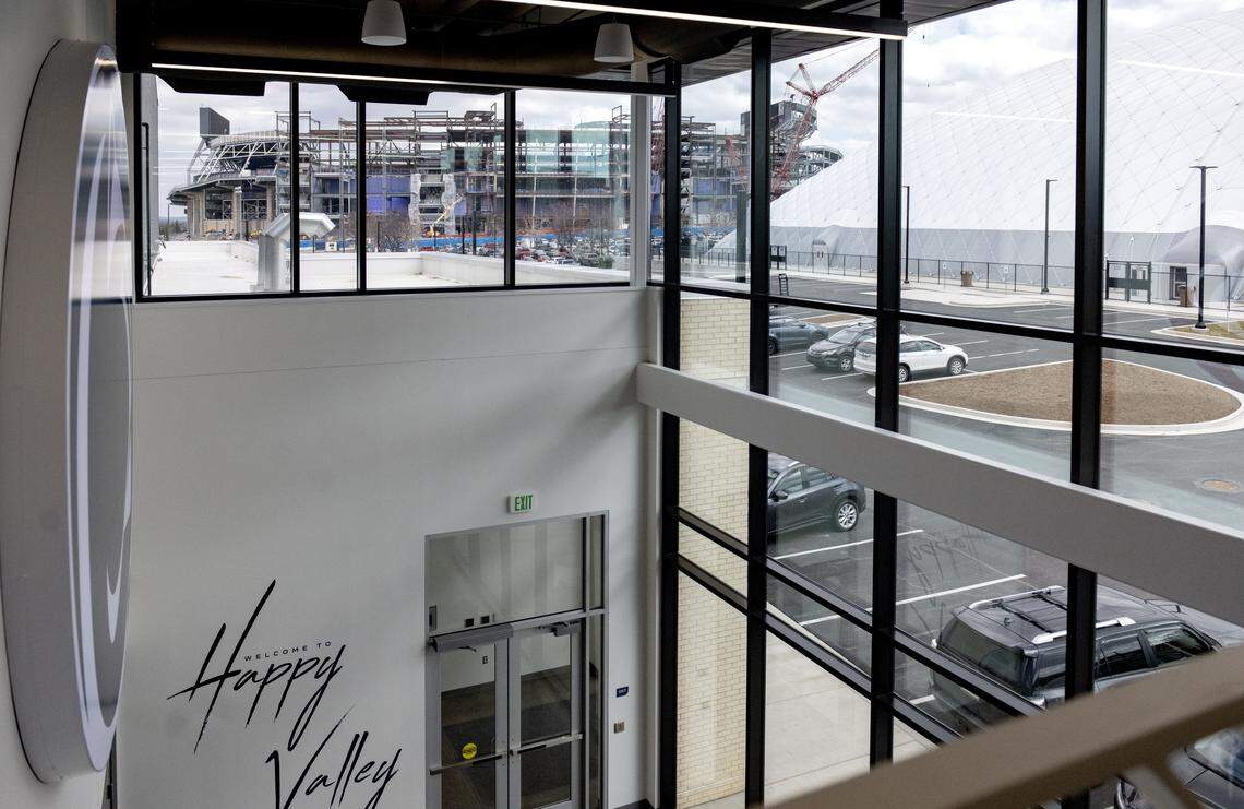 Beaver Stadium and the new practice bubble facility are seen through large windows at the Jeffrey Field Soccer Complex.
