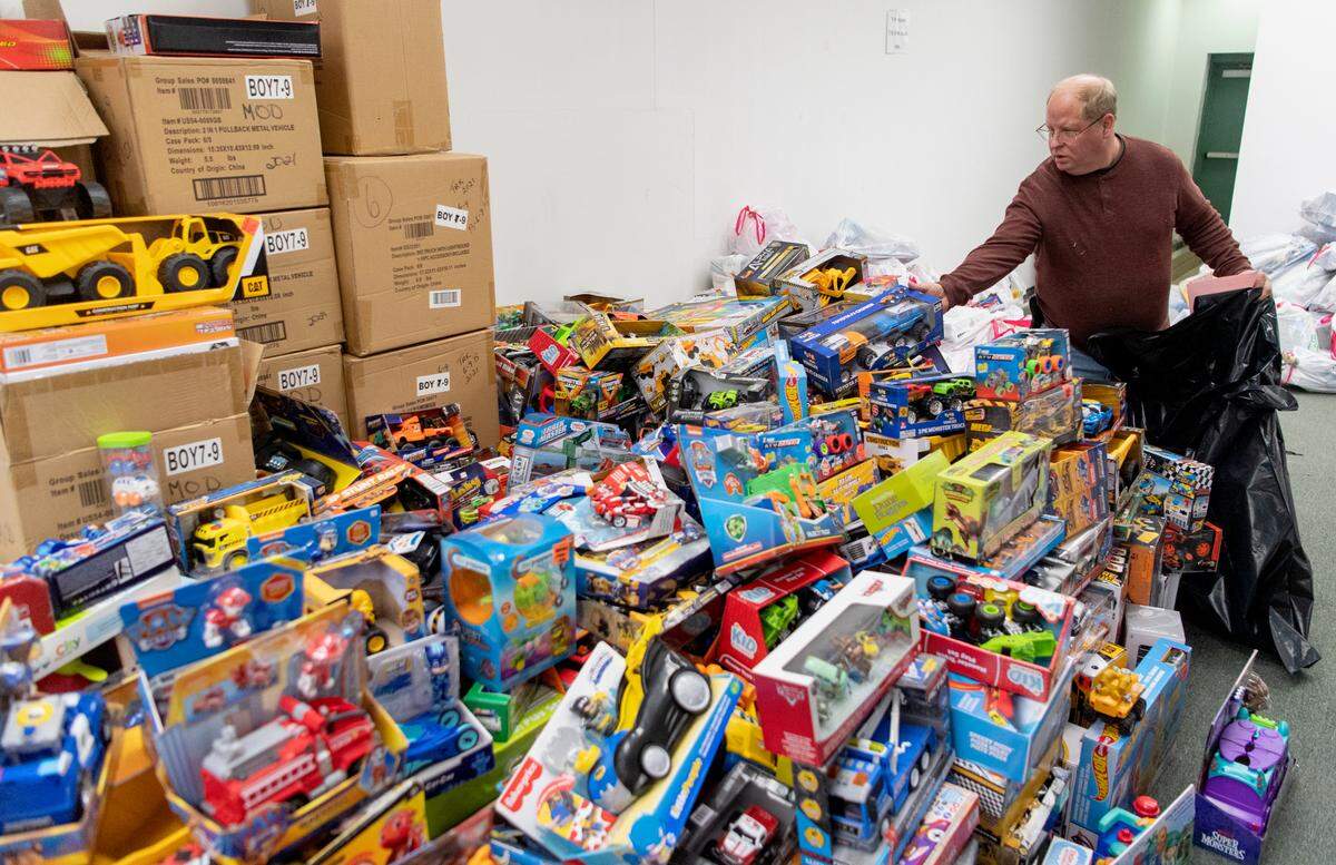 Bill Neumann picks out a truck for a youngster Tuesday at the Toys for Tots Unregistered Site, where Hundreds of toys are still available for area children.