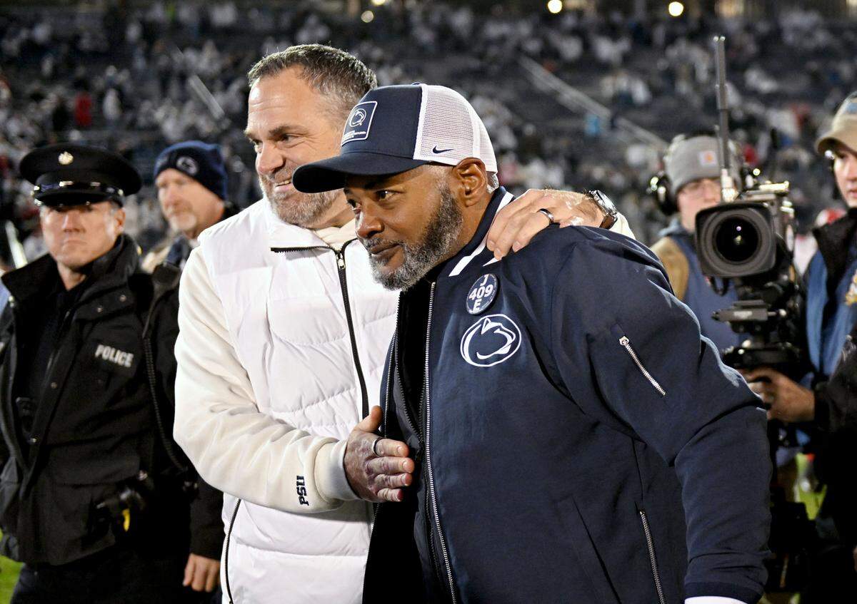 Penn State interim coach Terry Smith is congratulated by athletic director Pat Kraft after the win over Nebraska on Saturday, Nov. 22, 2025, at Beaver Stadium.
