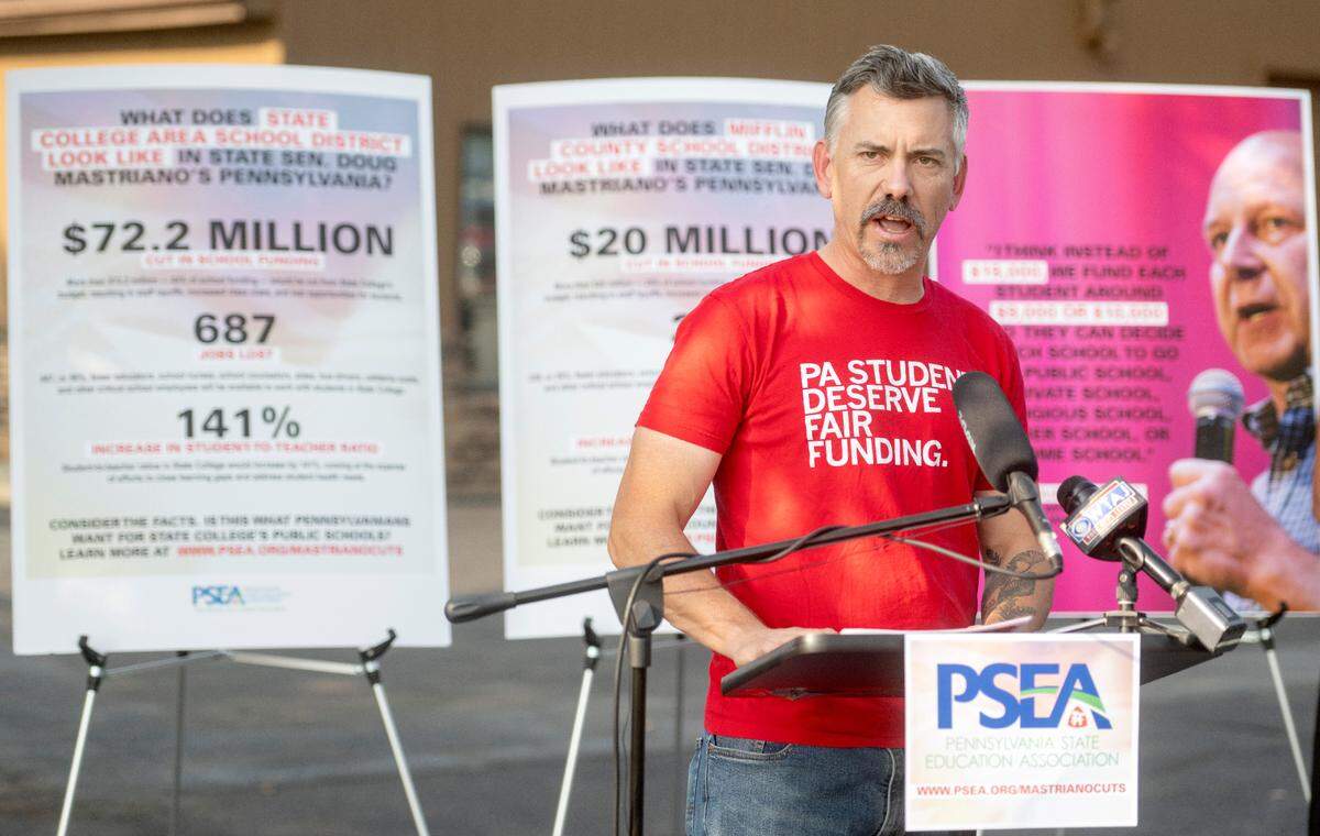 State College Area school board member Peter Buck gathers Friday with Pennsylvania State Education Association members to voice concerns about gubernatorial candidate Doug Mastriano’s proposed cuts to education funding.
